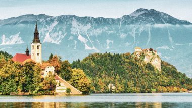 Lake Bled located in Slovenia Europe. There is a Church on the Island and ancient castle on top of a rock. Beautiful blue sky with dramatic cloudscape over the reflection in the Bled Lake. Story in such a beautiful sunny day on sunset. European Alps in the background.